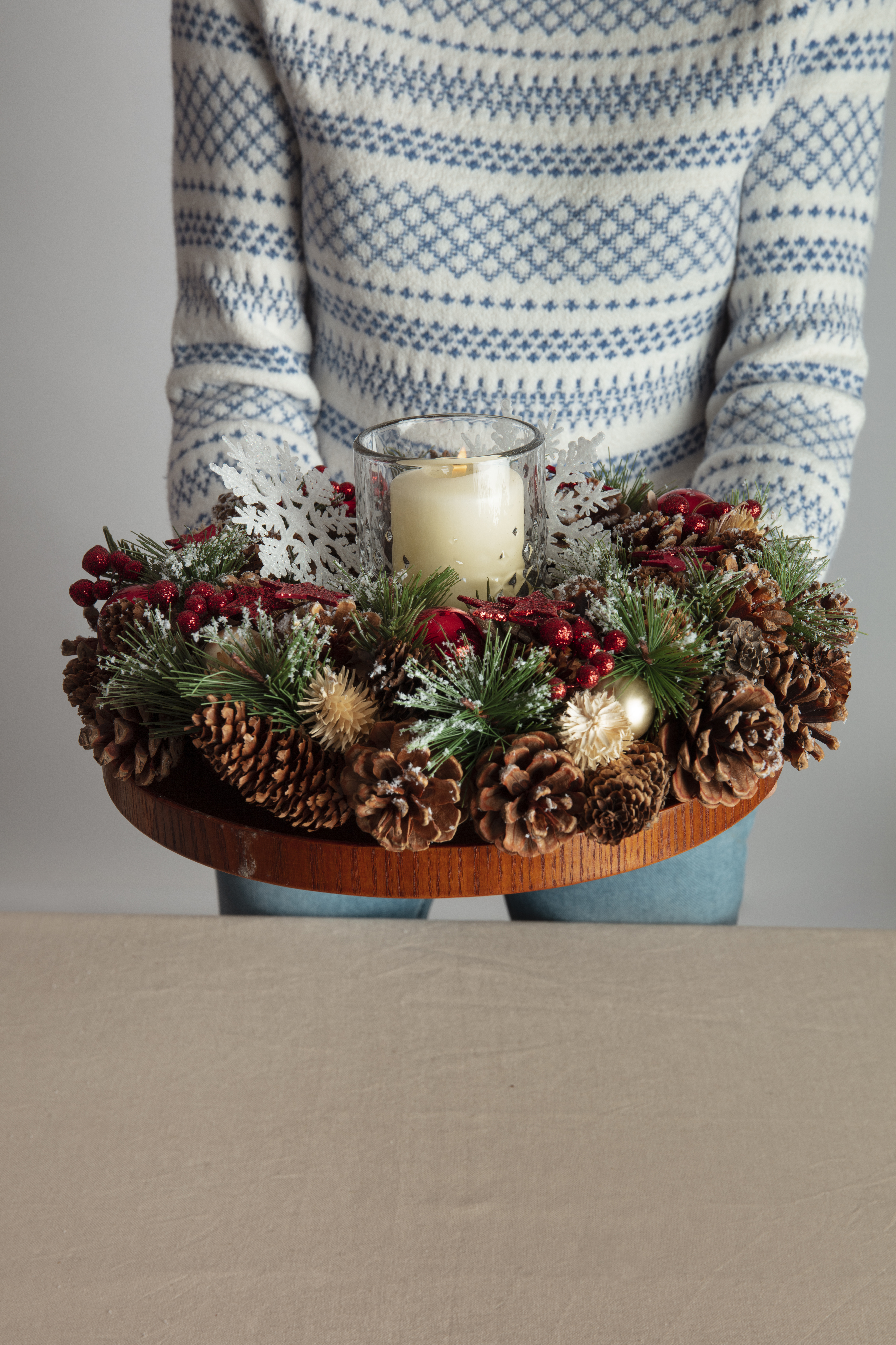  woman-holding-holiday-themed-wreath-her-hands
